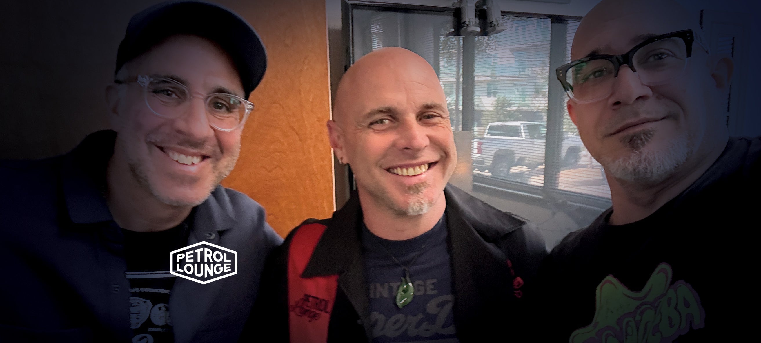 3 men smiling at Austin's petrol lounge