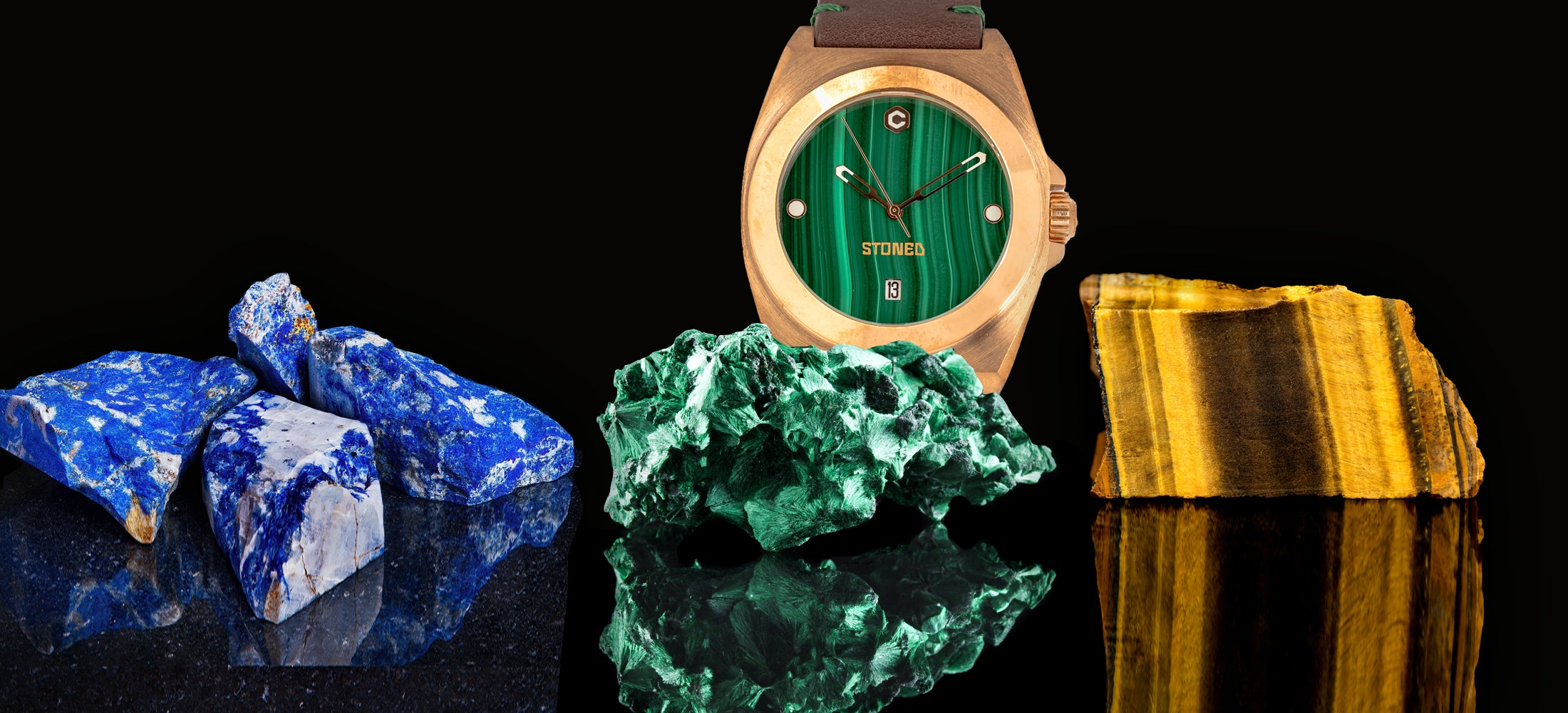 bronze women holding malavhite gemstone in front of a wall of lapis