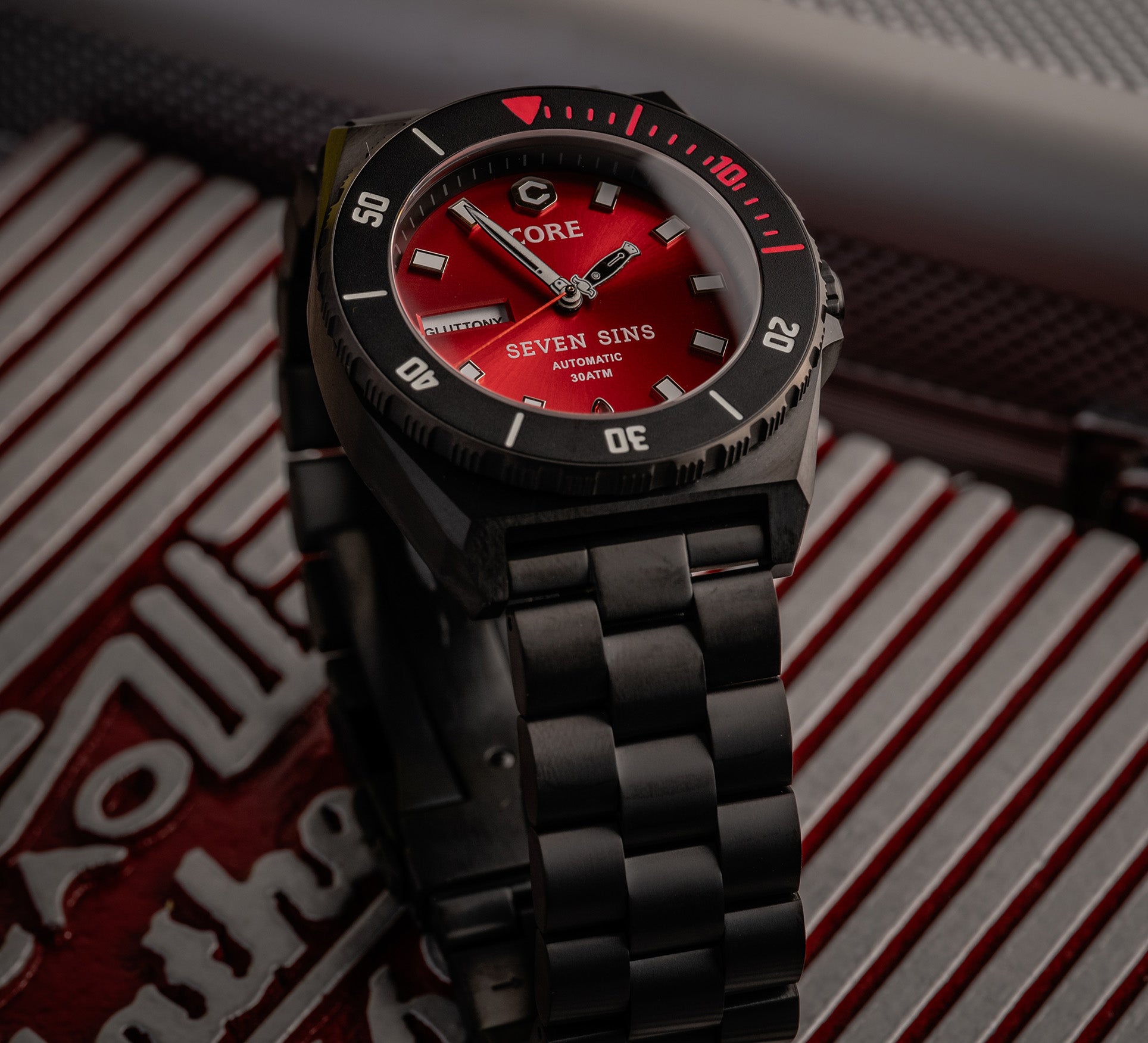 black titanium watch with red metallic dial