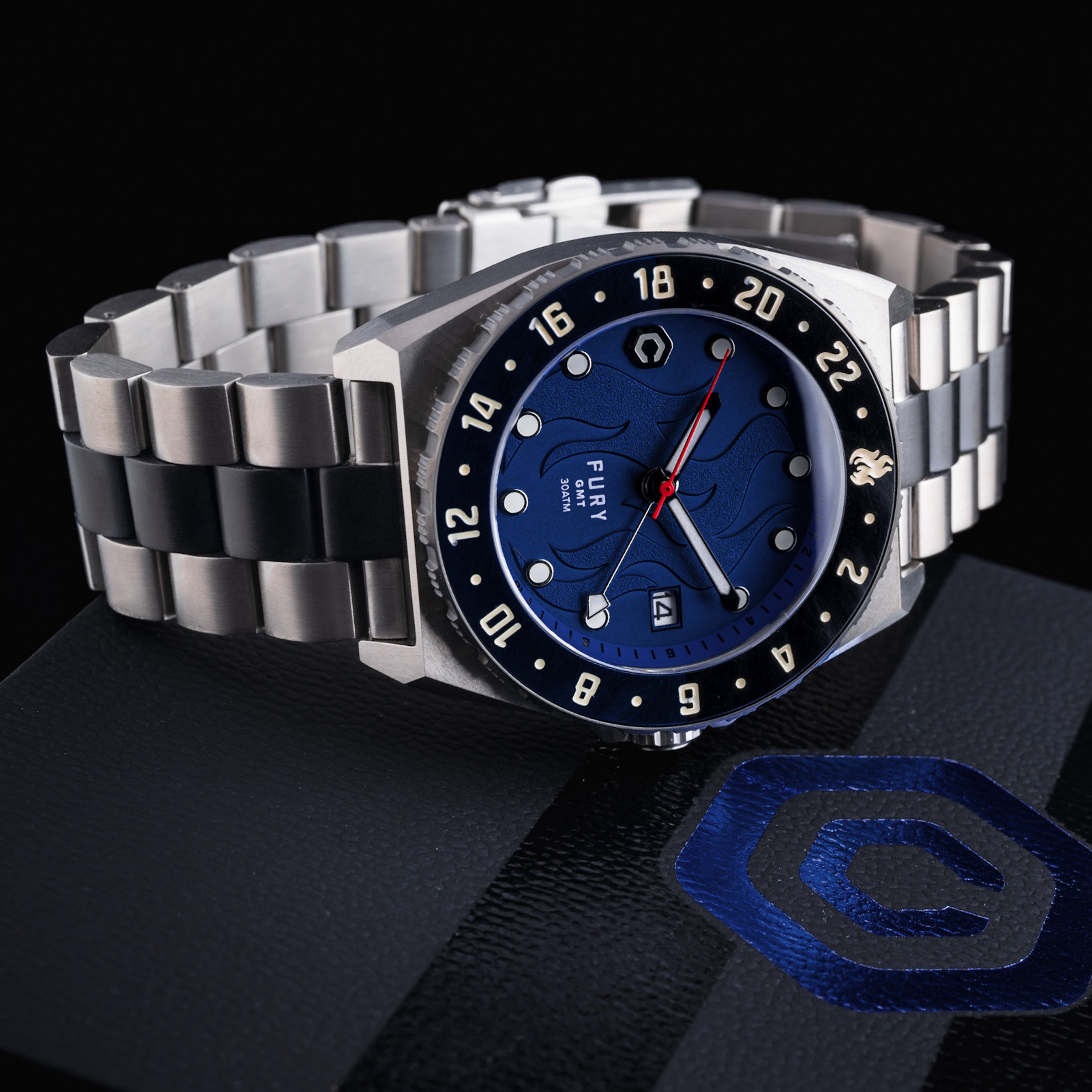 titanium automatic watch with dark blue flame dial on dark background