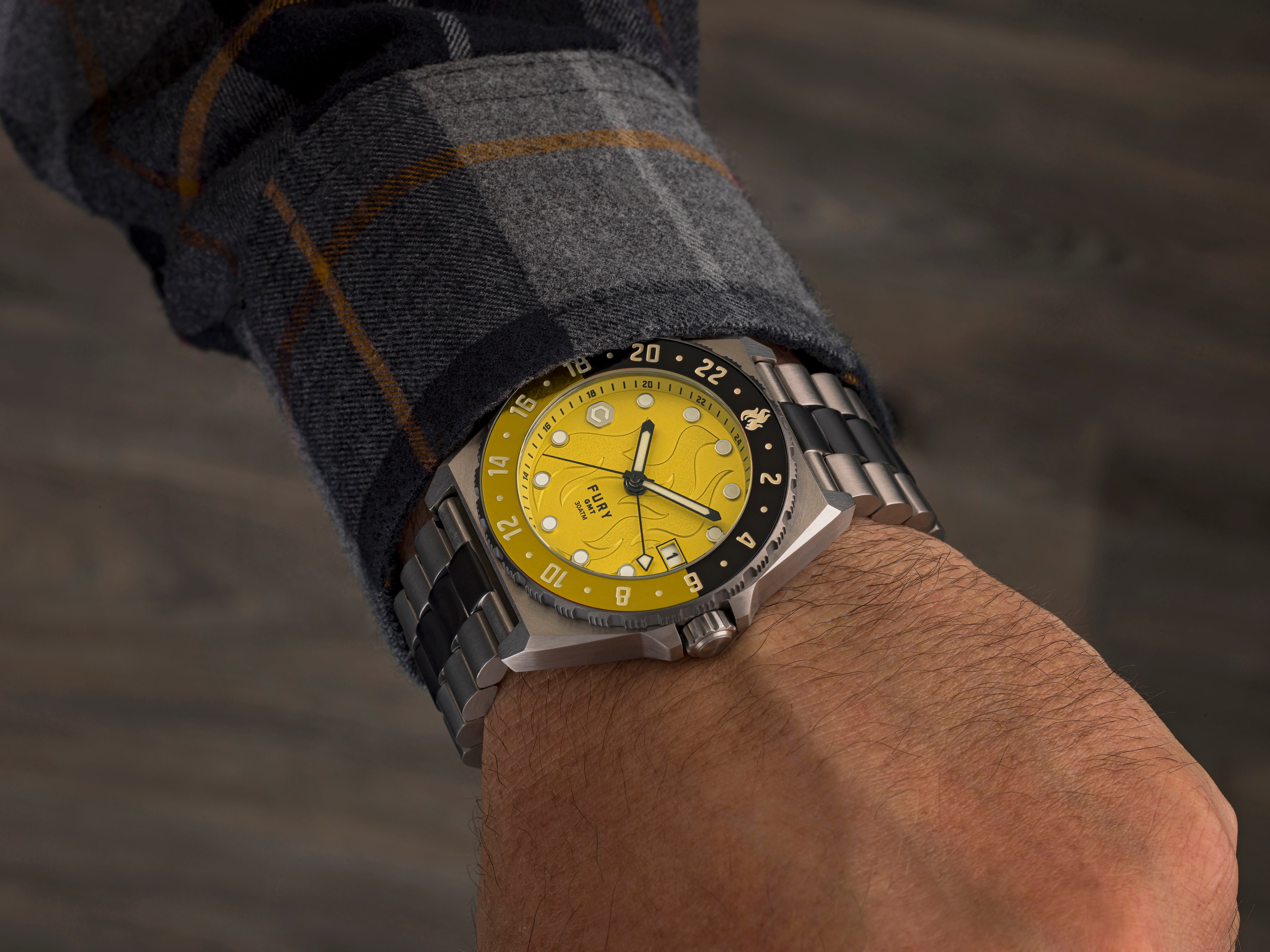 yellow dial and titanium case gmt automatic watch on man's wrist