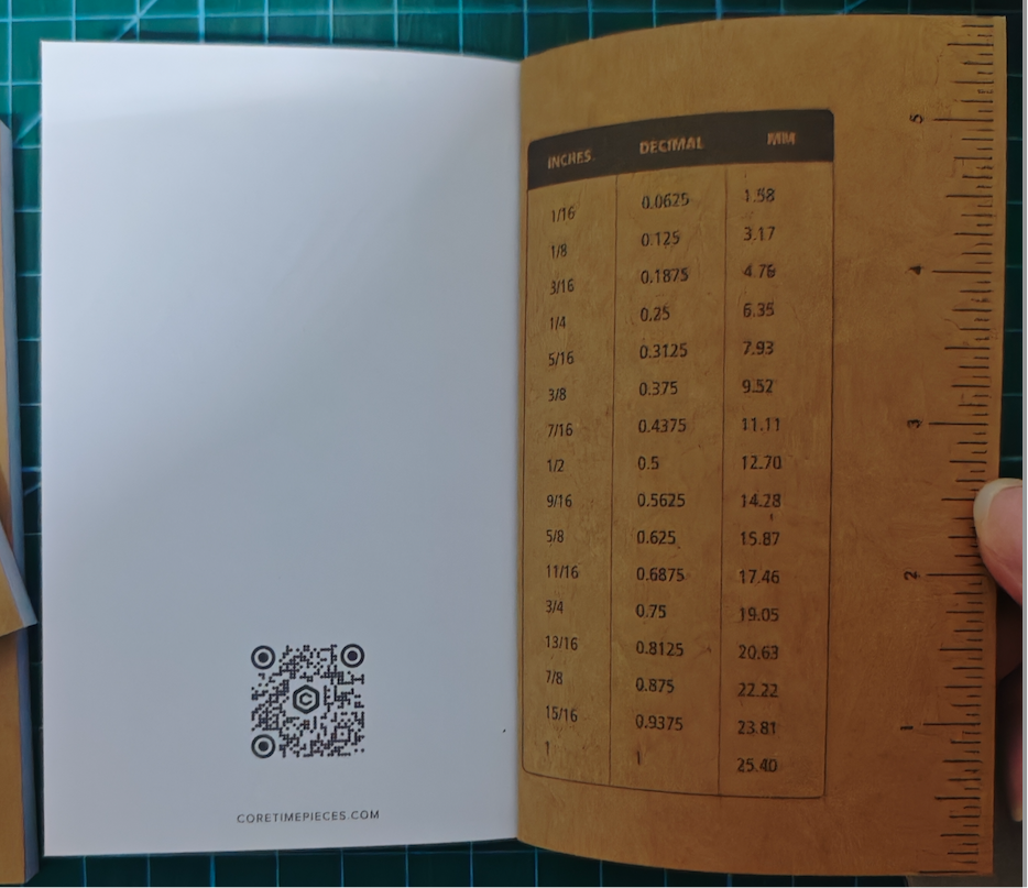 book opened to inside back cover showing a ruler and decimal conversions