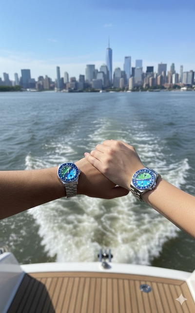 Two people holding hands with riverkeeper watches on a boat, city skyline in the background