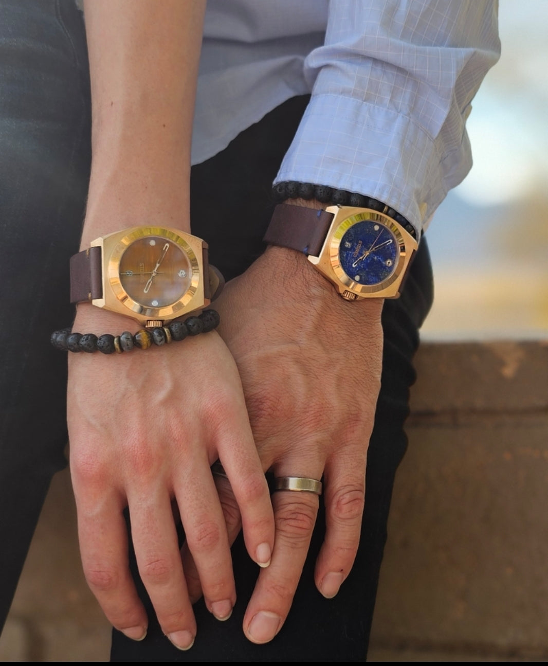 man and woman wearing bronze watch holding hands